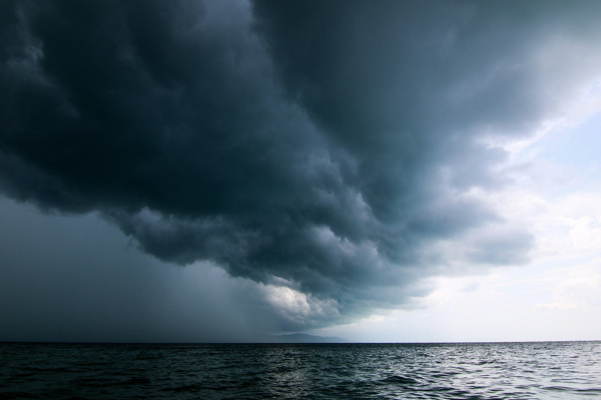 Dark storm clouds and rain moving in over the sea